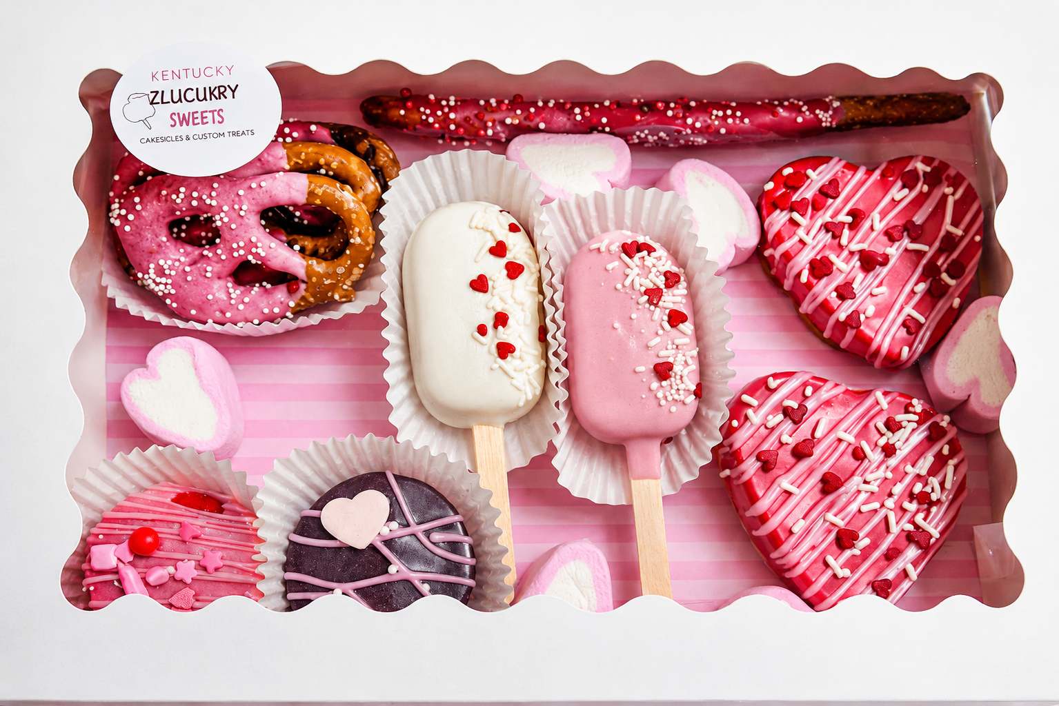 Valentine treat box with dipped pretzels, cakesicles, and decorated sweets